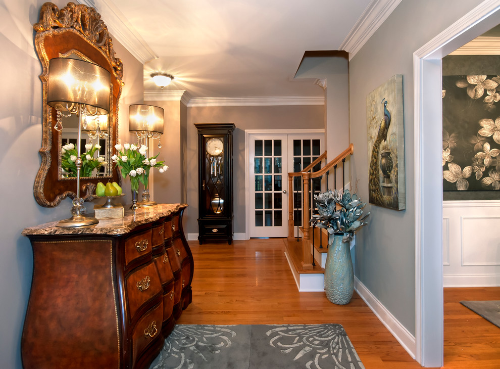 Inspiration for a large transitional medium tone wood floor entry hall remodel with gray walls