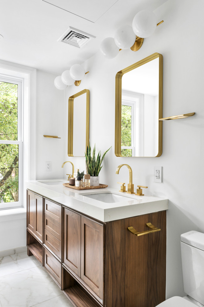 This is an example of a mid-sized transitional master bathroom in New York with furniture-like cabinets, brown cabinets, an alcove shower, a one-piece toilet, gray tile, ceramic tile, white walls, ceramic floors, a drop-in sink, marble benchtops, grey floor, an open shower, white benchtops, a shower seat, a double vanity and a freestanding vanity.