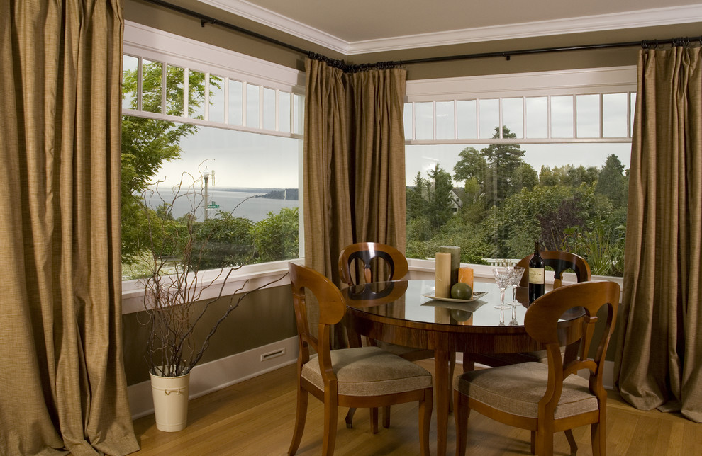 Photo of a traditional dining room in Seattle with brown walls and medium hardwood floors.