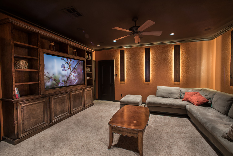 Large country open concept home theatre in Houston with orange walls, carpet and a wall-mounted tv.