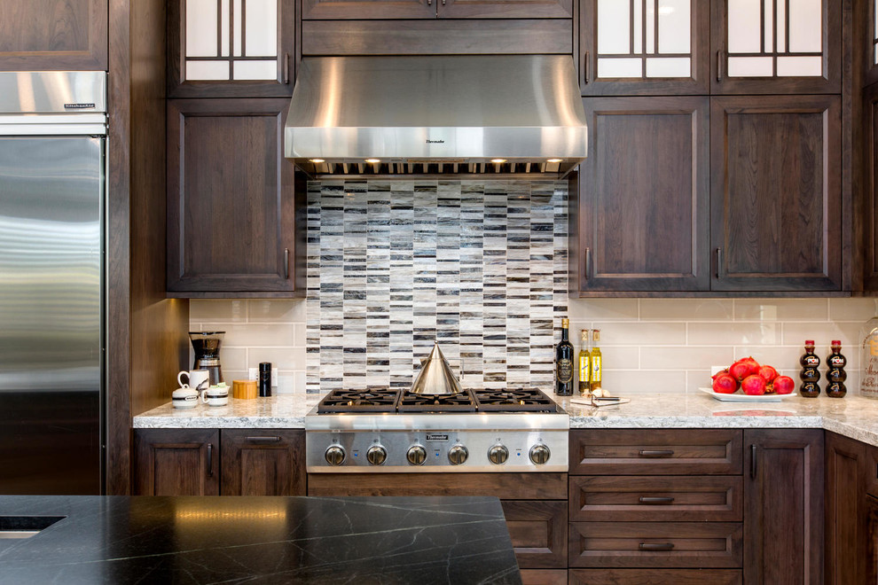 Kitchen - large transitional l-shaped porcelain tile and beige floor kitchen idea in Denver with an undermount sink, recessed-panel cabinets, medium tone wood cabinets, quartzite countertops, beige backsplash, glass tile backsplash, stainless steel appliances, an island and white countertops