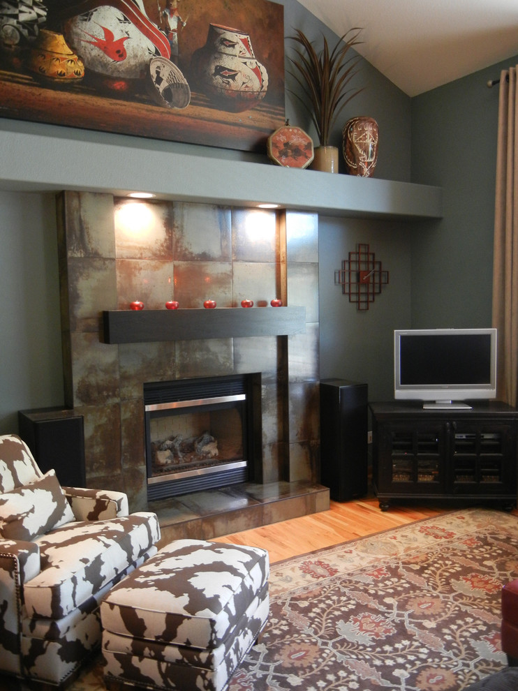 Photo of a mid-sized traditional open concept family room in Denver with grey walls, medium hardwood floors, a standard fireplace, a tile fireplace surround and a corner tv.