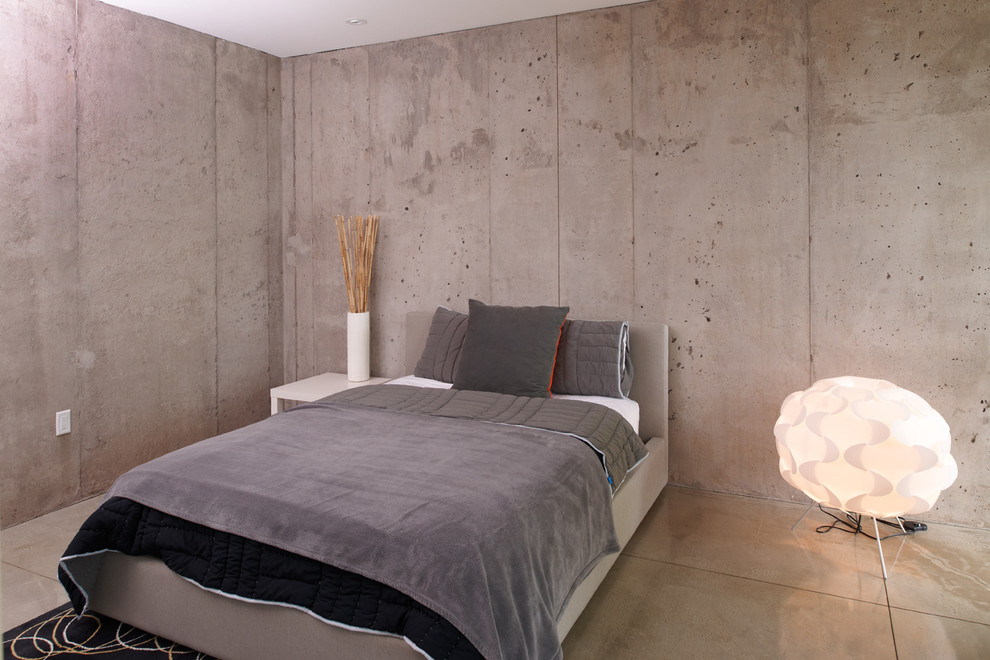 This is an example of a modern bedroom in Minneapolis with concrete floors.