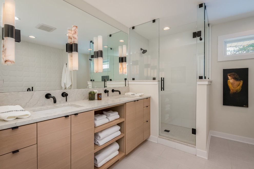Design ideas for a large midcentury master bathroom in New York with flat-panel cabinets, light wood cabinets, a corner shower, a one-piece toilet, white tile, ceramic tile, grey walls, ceramic floors, an undermount sink, engineered quartz benchtops, white floor, a hinged shower door and white benchtops.