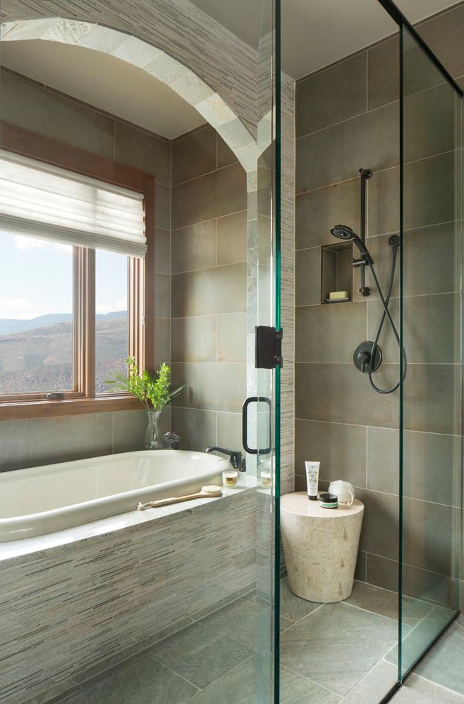 Large country master wet room bathroom in Denver with raised-panel cabinets, medium wood cabinets, a drop-in tub, green tile, porcelain tile, beige walls, slate floors, an undermount sink, granite benchtops, green floor, a hinged shower door and beige benchtops.