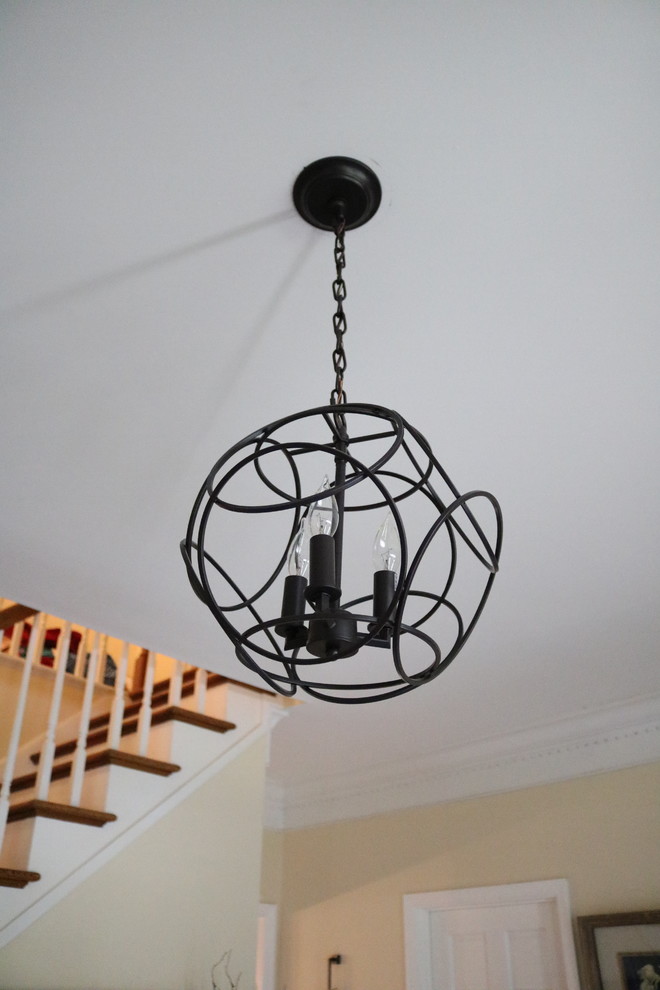 Inspiration for a small transitional medium tone wood floor foyer remodel in Cincinnati with yellow walls
