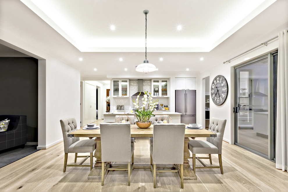 Mid-sized transitional open plan dining in Toronto with grey walls and light hardwood floors.