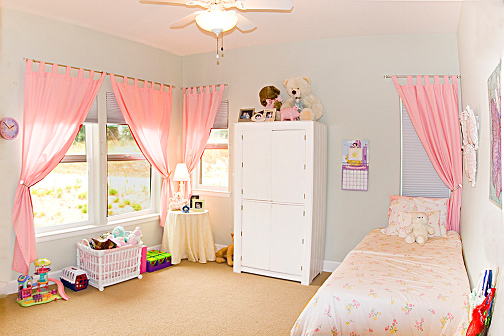 Photo of a mid-sized arts and crafts kids' bedroom for kids 4-10 years old and girls in San Luis Obispo with blue walls and carpet.
