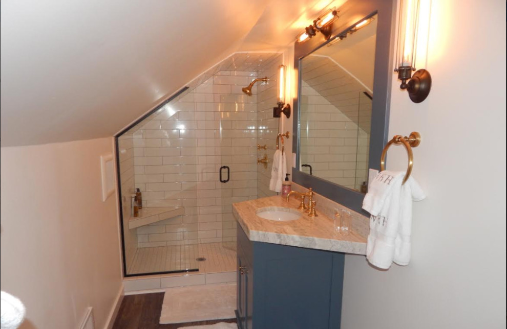 Alcove shower - small transitional 3/4 white tile and ceramic tile dark wood floor and brown floor alcove shower idea with shaker cabinets, gray cabinets, white walls, an undermount sink, quartzite countertops, a hinged shower door and beige countertops