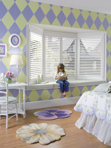 This is an example of a large eclectic kids' bedroom for kids 4-10 years old and girls in Richmond with multi-coloured walls and medium hardwood floors.