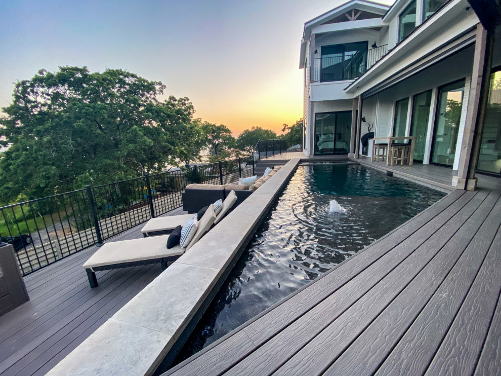 This is an example of a small country rooftop custom-shaped aboveground pool in Dallas with with privacy feature and decking.