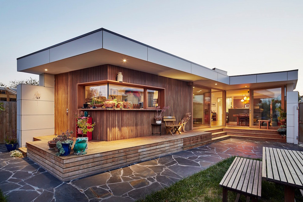 Photo of a mid-sized scandinavian backyard deck in Melbourne with a roof extension.