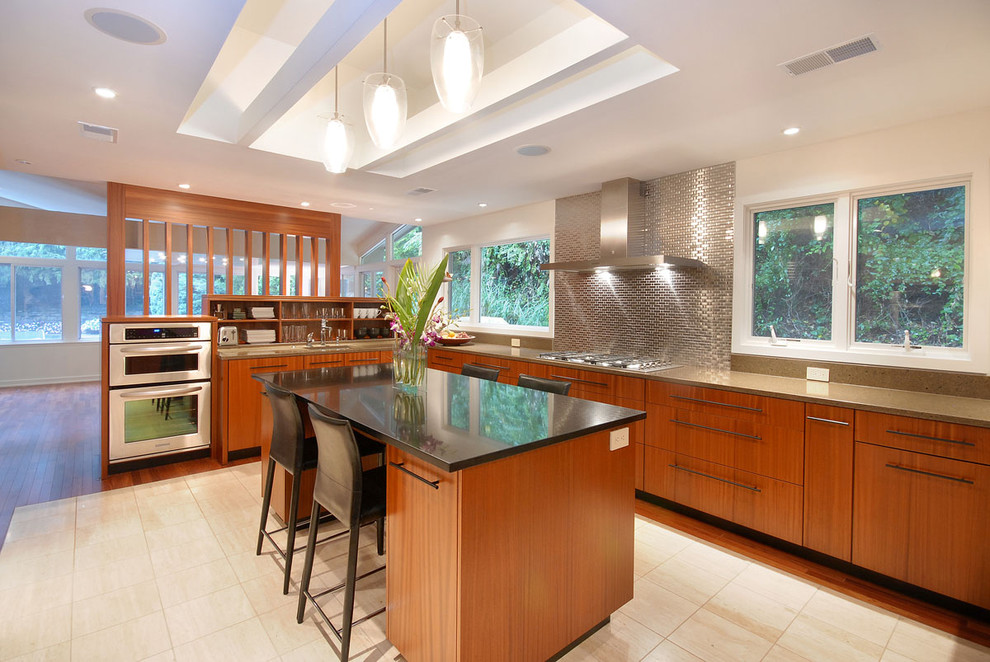 Photo of a contemporary kitchen in Philadelphia with stainless steel appliances, flat-panel cabinets, medium wood cabinets, metallic splashback and metal splashback.