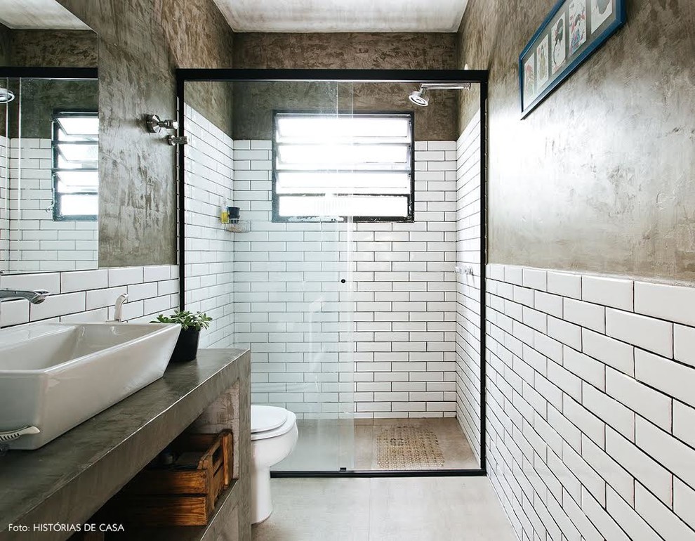 Inspiration for a mid-sized transitional 3/4 bathroom in Boston with open cabinets, distressed cabinets, an alcove tub, an alcove shower, a two-piece toilet, white tile, subway tile, brown walls, a drop-in sink, concrete benchtops, a sliding shower screen and grey benchtops.