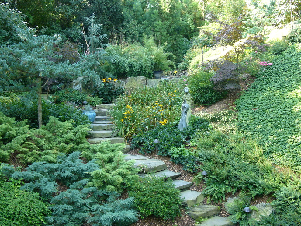 Photo of a large asian side yard shaded garden in New York with a garden path and natural stone pavers.