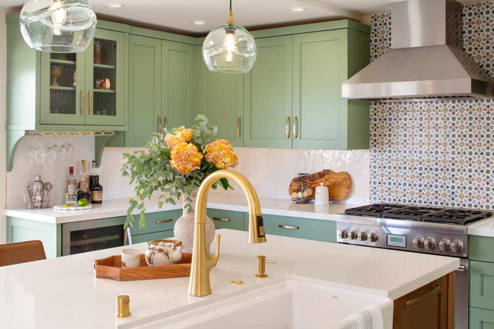 Large traditional l-shaped kitchen in San Diego with a belfast sink, recessed-panel cabinets, green cabinets, multi-coloured splashback, ceramic splashback, stainless steel appliances and an island.