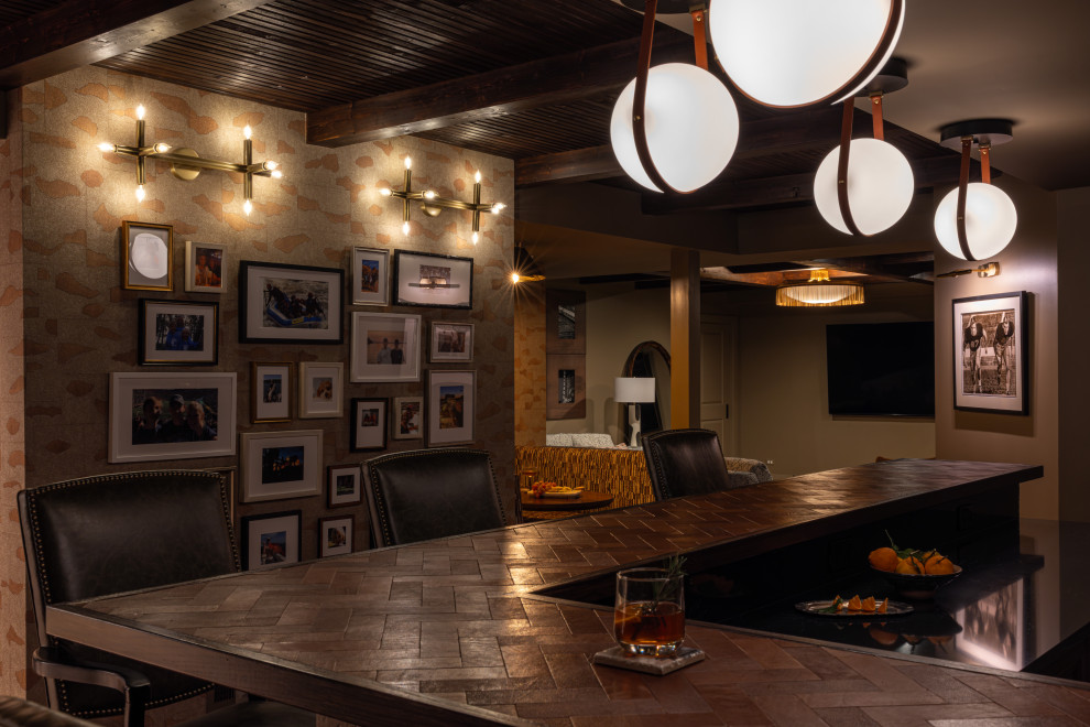 Example of a transitional medium tone wood floor, wood ceiling and wallpaper basement design in Chicago with a bar and green walls