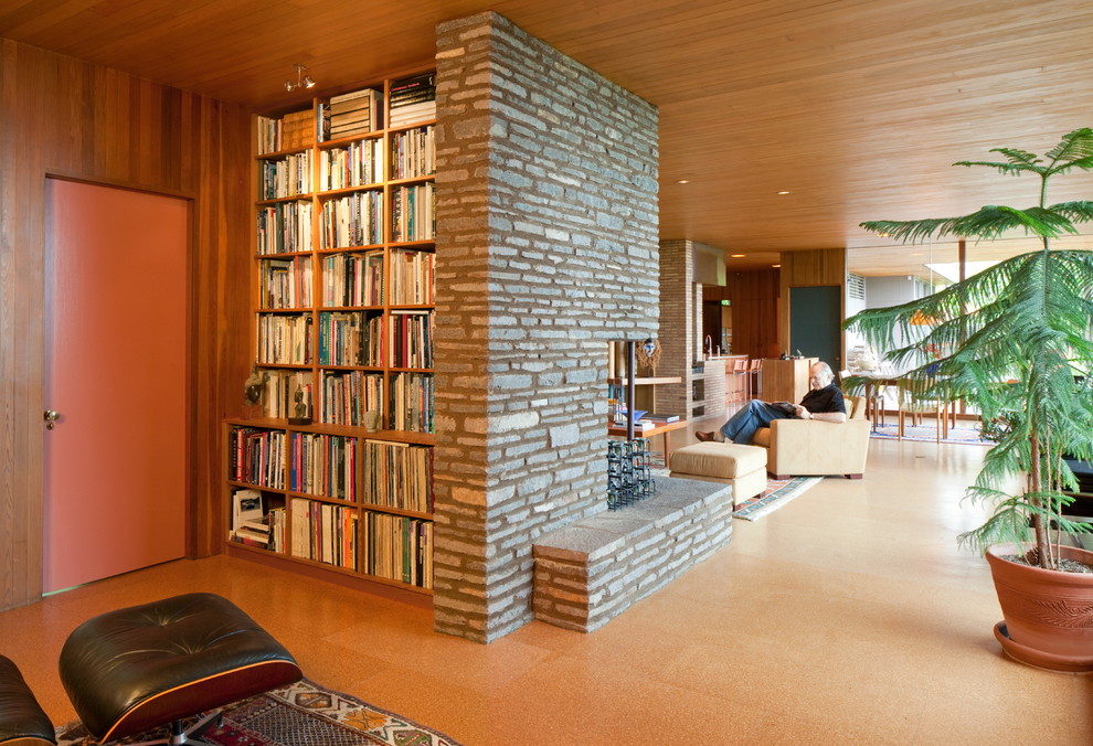 Photo of a mid-sized midcentury formal enclosed living room in Portland with no tv, cork floors, a standard fireplace and a stone fireplace surround.
