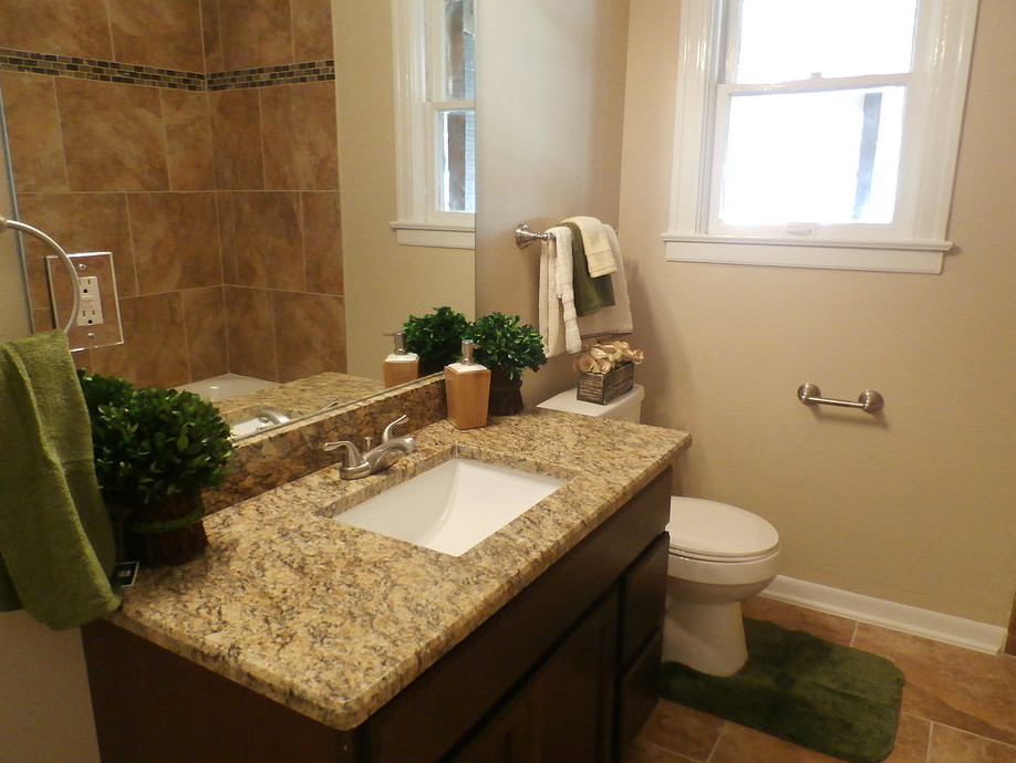 Design ideas for a small traditional bathroom in Austin with an undermount sink, flat-panel cabinets, dark wood cabinets, granite benchtops, an alcove tub, a shower/bathtub combo, a two-piece toilet, beige tile, ceramic tile, beige walls and ceramic floors.