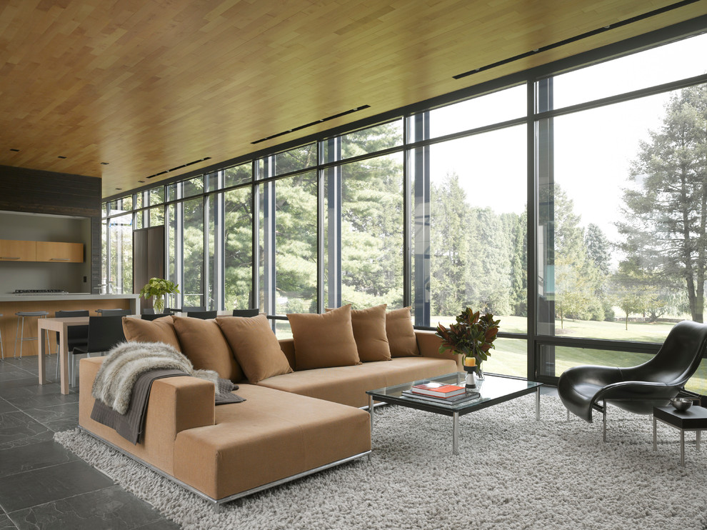 Photo of a large contemporary open concept living room in New York with slate floors.