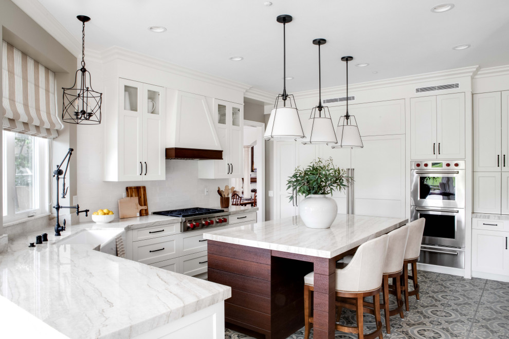 Inspiration for a transitional kitchen in Orange County with a farmhouse sink, stainless steel appliances, cement tiles, with island, shaker cabinets, white cabinets, white splashback, multi-coloured floor and multi-coloured benchtop.