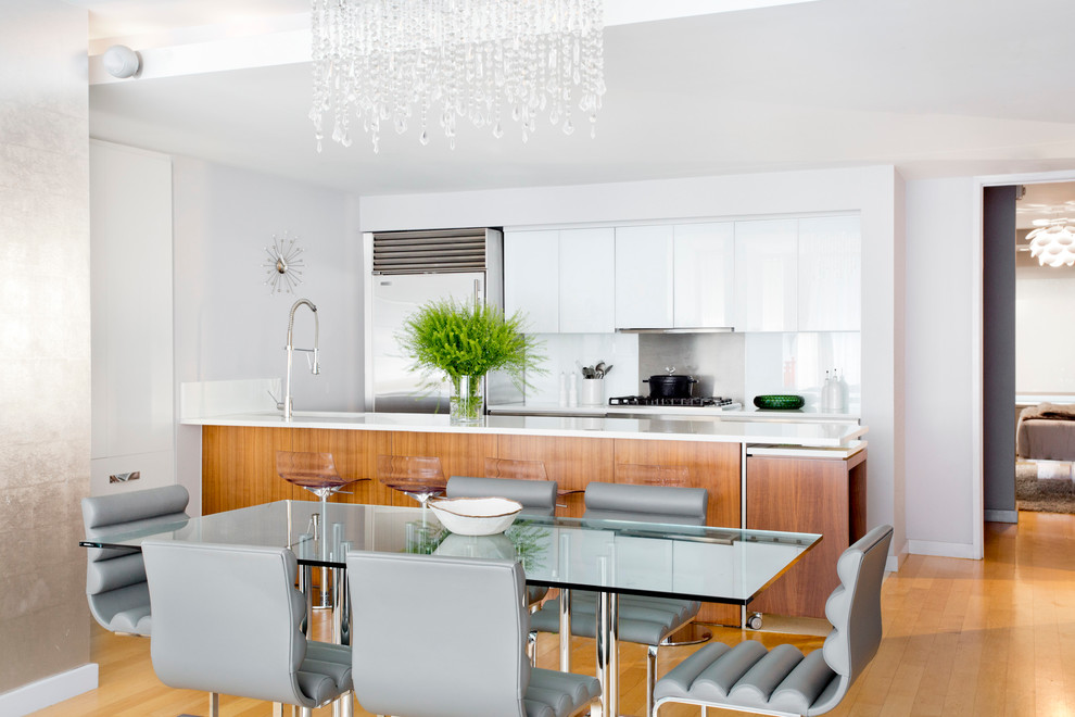 Design ideas for a contemporary kitchen/dining combo in New York with white walls and light hardwood floors.