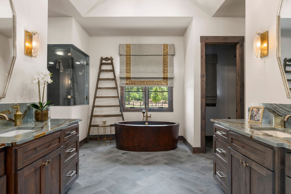 Design ideas for a country bathroom in Austin with shaker cabinets, dark wood cabinets, a freestanding tub, white walls, an undermount sink, grey floor, grey benchtops, an enclosed toilet, a single vanity, a built-in vanity and vaulted.