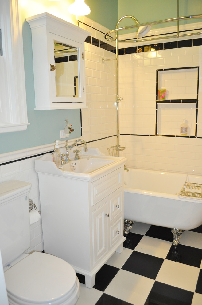 Inspiration for a small traditional master bathroom in San Francisco with a claw-foot tub, subway tile, raised-panel cabinets, white cabinets, a two-piece toilet, black and white tile, blue walls, porcelain floors and a console sink.