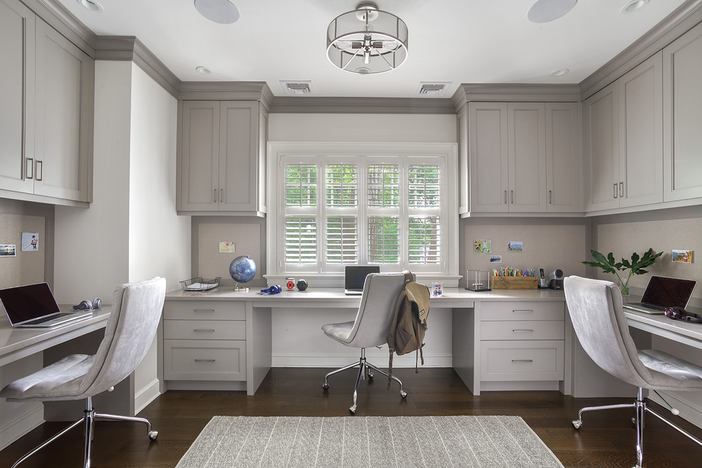 Transitional Kids - Example of a study space and mid-sized transitional gender-neutral dark wood floor and brown floor kids' study room design in New York with gray walls