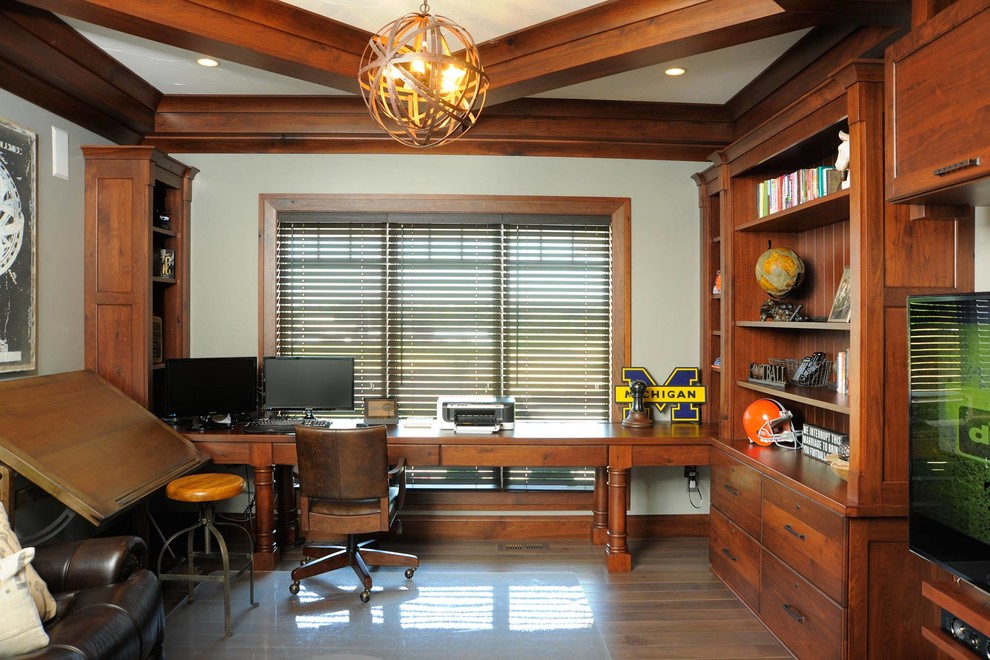 Inspiration for a mid-sized arts and crafts study room in Cleveland with beige walls, medium hardwood floors and a built-in desk.