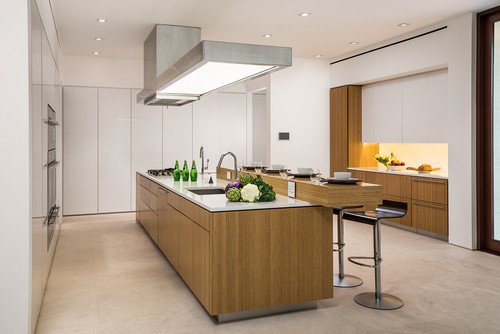 Modern kitchen with handleless RTA cabinets, wood island, and seamless white tall units