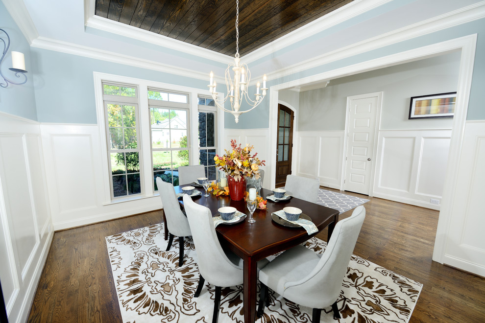 Traditional separate dining room in Raleigh with blue walls, medium hardwood floors and no fireplace.