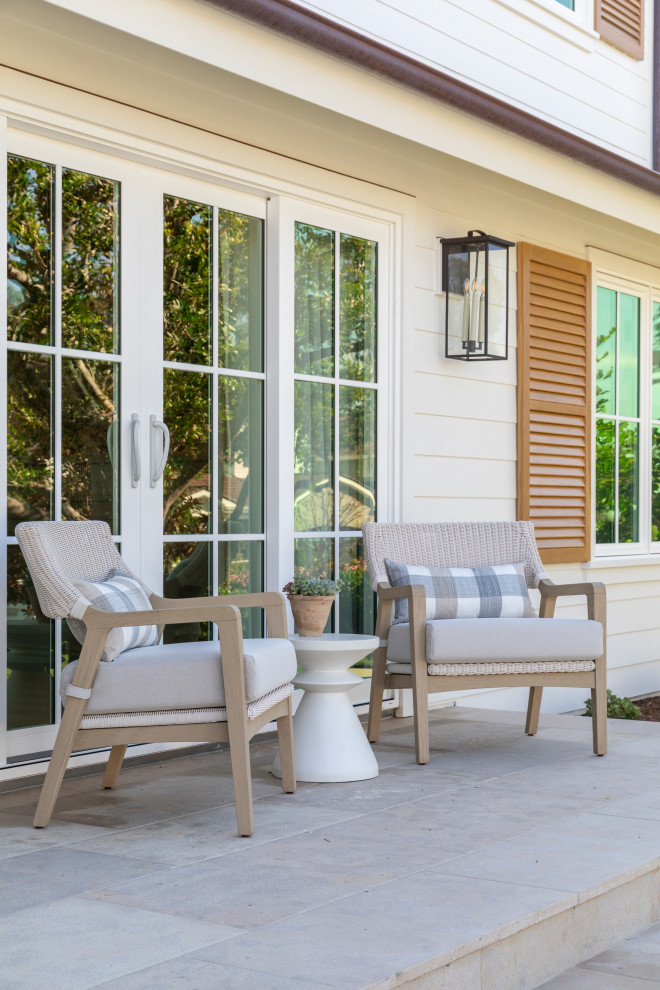 Beach style stone front porch photo in Orange County