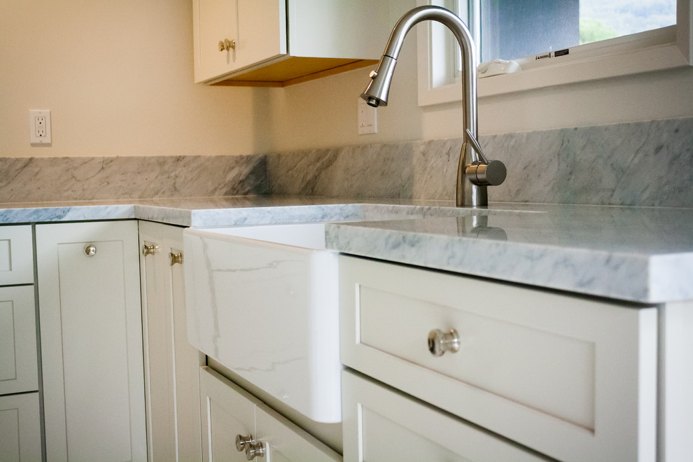 Kitchen - transitional kitchen idea in San Francisco with a farmhouse sink, white cabinets and marble countertops