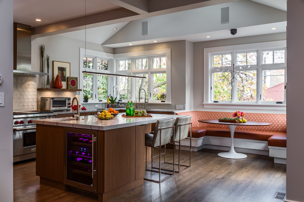 This is an example of a mid-sized contemporary u-shaped eat-in kitchen in Chicago with a single-bowl sink, flat-panel cabinets, light wood cabinets, quartz benchtops, white splashback, glass tile splashback, stainless steel appliances, dark hardwood floors and with island.