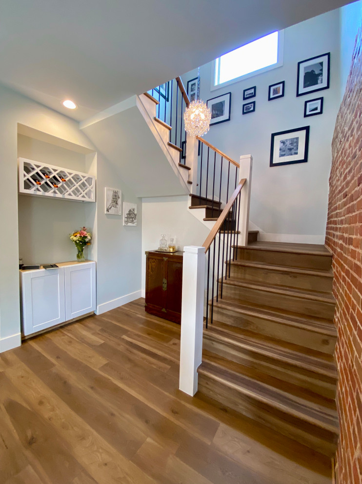 Inspiration for a large transitional wood u-shaped staircase in Denver with wood risers, mixed railing and brick walls.