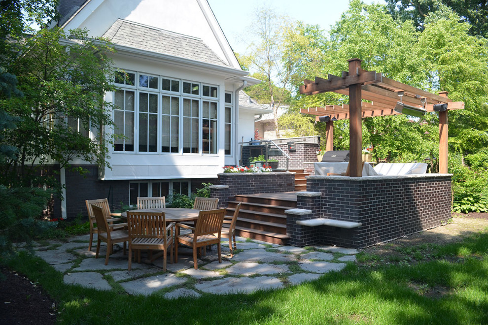 Photo of a mid-sized transitional backyard deck in Chicago with a fire feature and a pergola.
