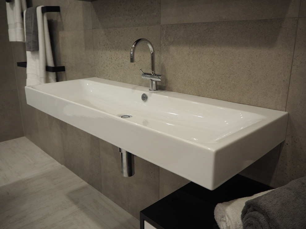 Inspiration for a large contemporary master bathroom in Sydney with white cabinets, a wall-mount sink, flat-panel cabinets, a freestanding tub, a double shower, a wall-mount toilet, gray tile, porcelain tile, grey walls, porcelain floors, white floor, an open shower, a niche, a single vanity and a floating vanity.