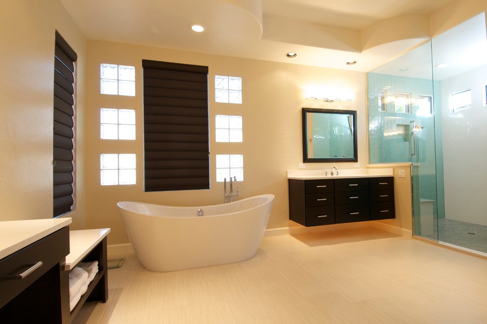 Inspiration for a modern bathroom in Phoenix with shaker cabinets, dark wood cabinets, an undermount sink, granite benchtops, a freestanding tub, an alcove shower, beige tile, subway tile, beige walls, bamboo floors and a hinged shower door.