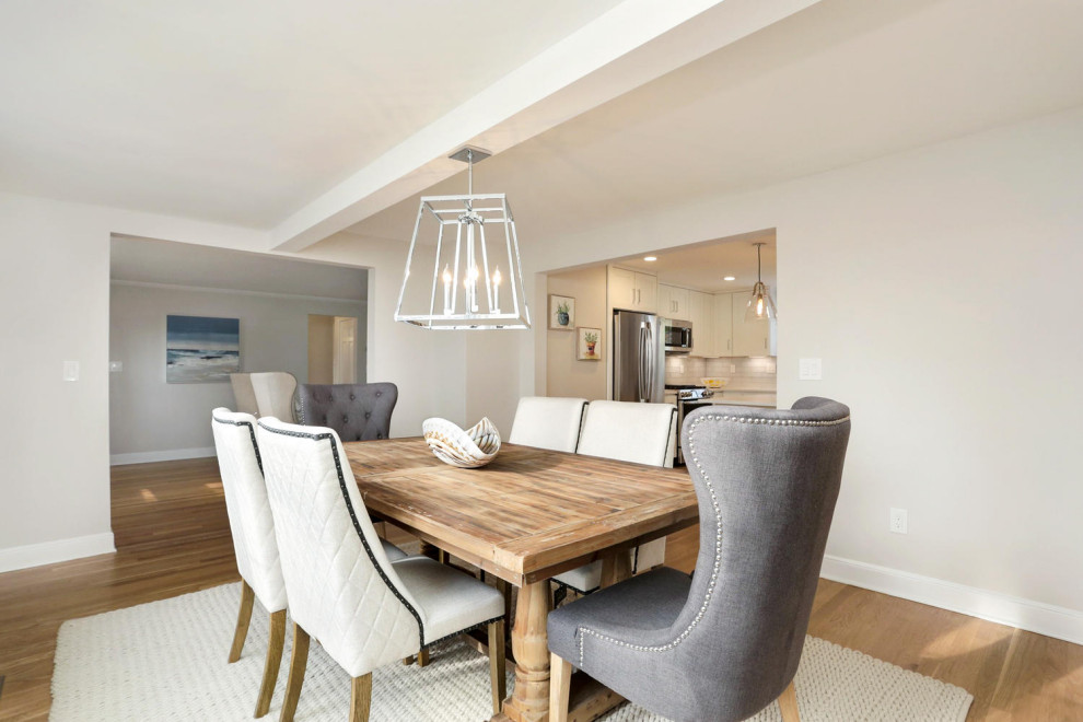 Beach style dining room in New York with grey walls and medium hardwood floors.