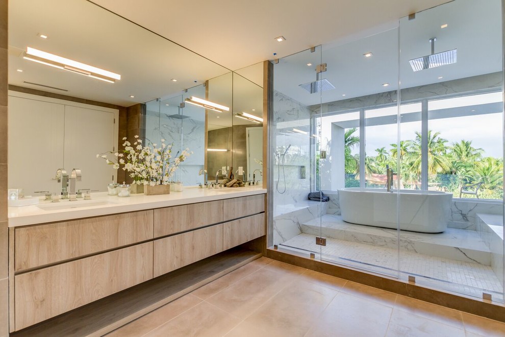 Design ideas for a large contemporary master bathroom in Miami with flat-panel cabinets, beige cabinets, a freestanding tub, a double shower, an undermount sink, beige floor, a hinged shower door, white tile, marble, brown walls and engineered quartz benchtops.