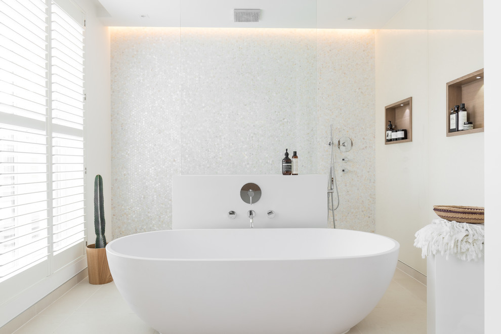 This is an example of a large contemporary master bathroom in London with a freestanding tub, white walls and a curbless shower.