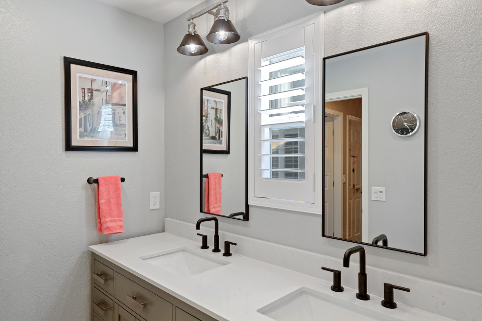 This is an example of a modern bathroom in Sacramento with brown cabinets, an alcove tub, a shower/bathtub combo, grey walls, an undermount sink, engineered quartz benchtops, a shower curtain, white benchtops, a double vanity and a built-in vanity.