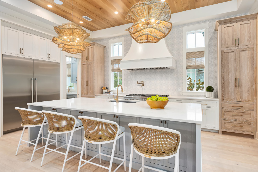 Example of a large beach style u-shaped light wood floor and wood ceiling eat-in kitchen design in Miami with an undermount sink, shaker cabinets, light wood cabinets, quartz countertops, stainless steel appliances, an island and white countertops