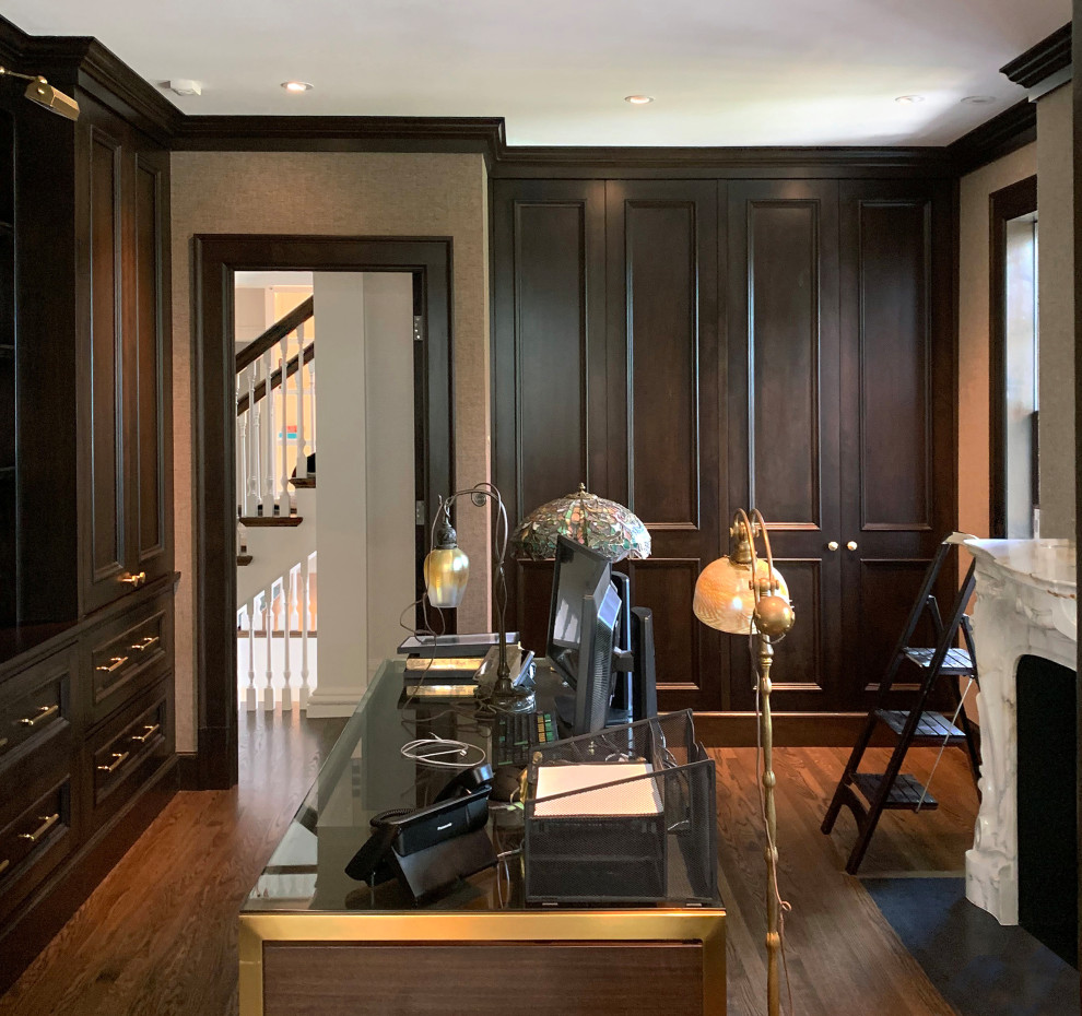 Large traditional study room in Chicago with beige walls, medium hardwood floors, a standard fireplace, a stone fireplace surround, a freestanding desk and beige floor.