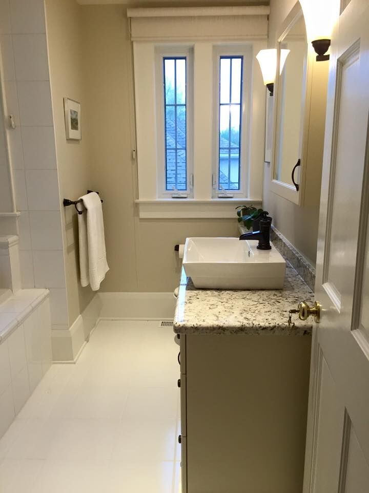 Inspiration for a large transitional bathroom in Toronto with flat-panel cabinets, beige cabinets, an alcove tub, a shower/bathtub combo, beige walls, a drop-in sink, granite benchtops, porcelain floors and white floor.
