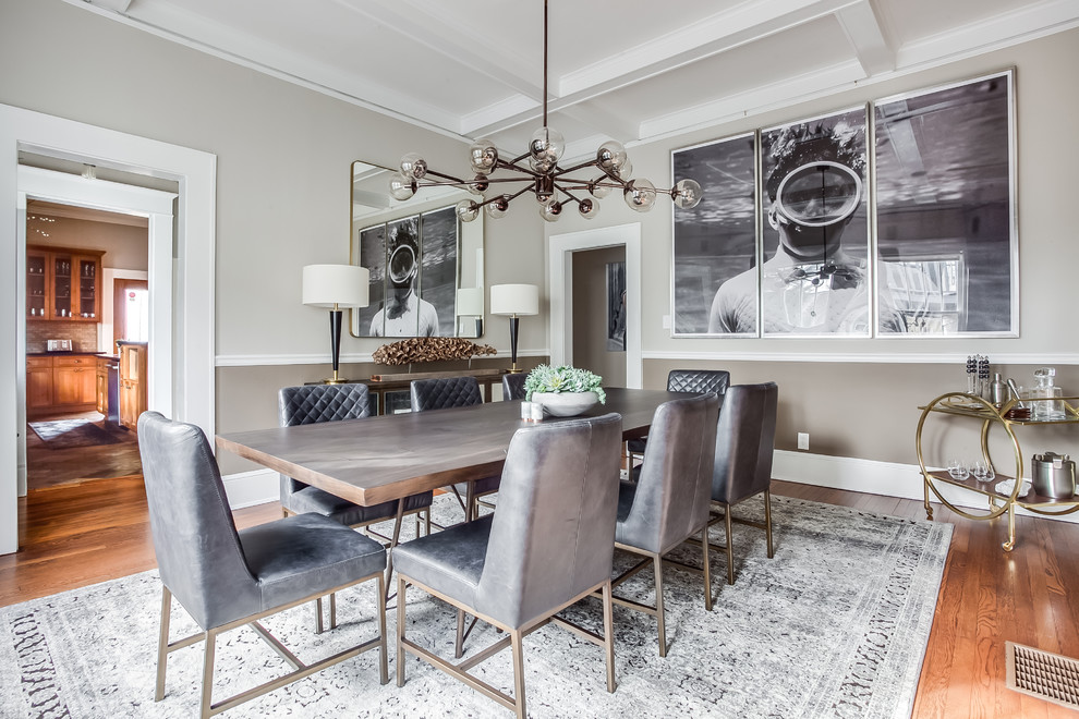 This is an example of a transitional separate dining room in Atlanta with grey walls, medium hardwood floors and brown floor.