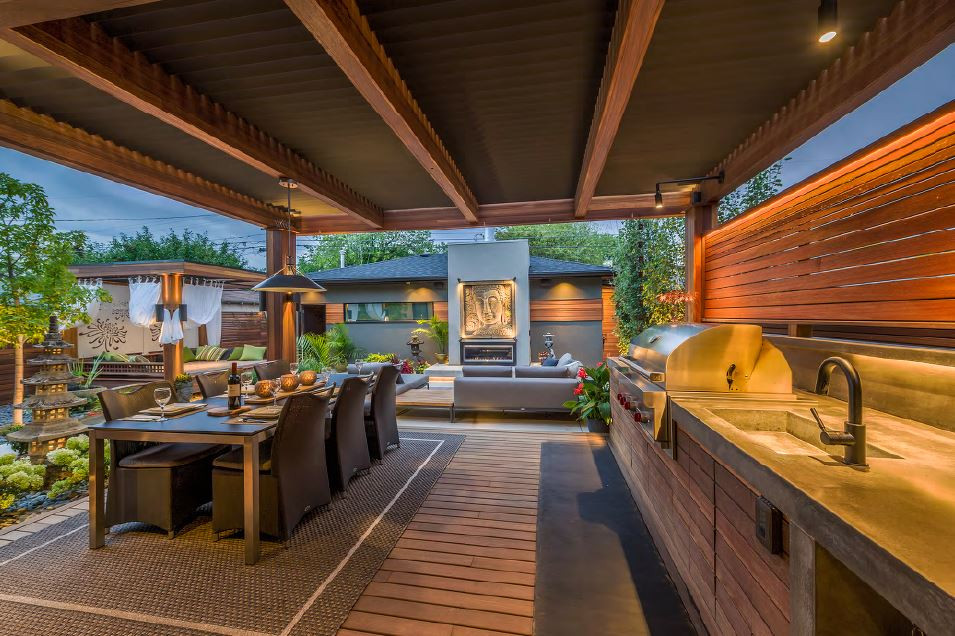 Inspiration for a mid-sized transitional backyard deck remodel in Calgary with a pergola