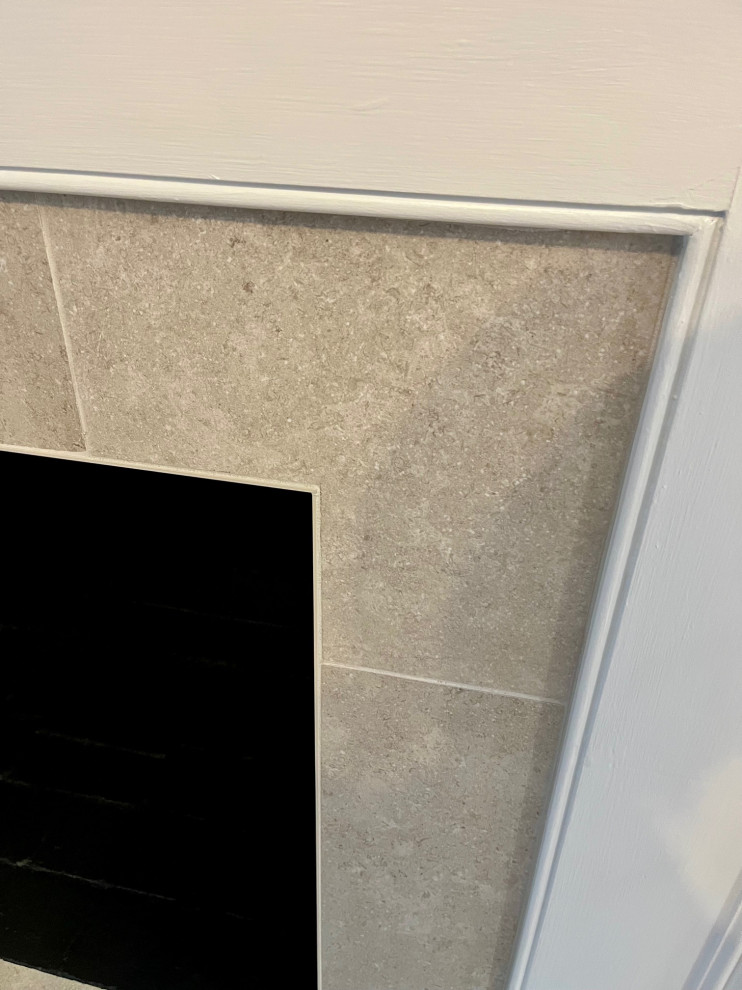 Inspiration for a mid-sized transitional vinyl floor and brown floor kitchen/dining room combo remodel with white walls, a standard fireplace and a tile fireplace