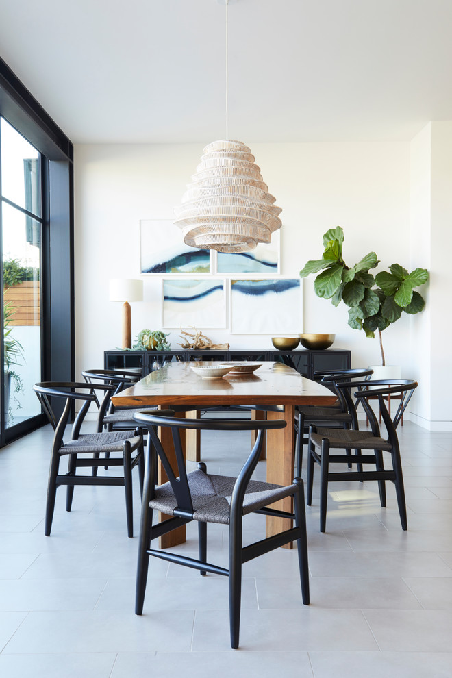 Mid-sized contemporary dining room in Orange County with white walls and grey floor.